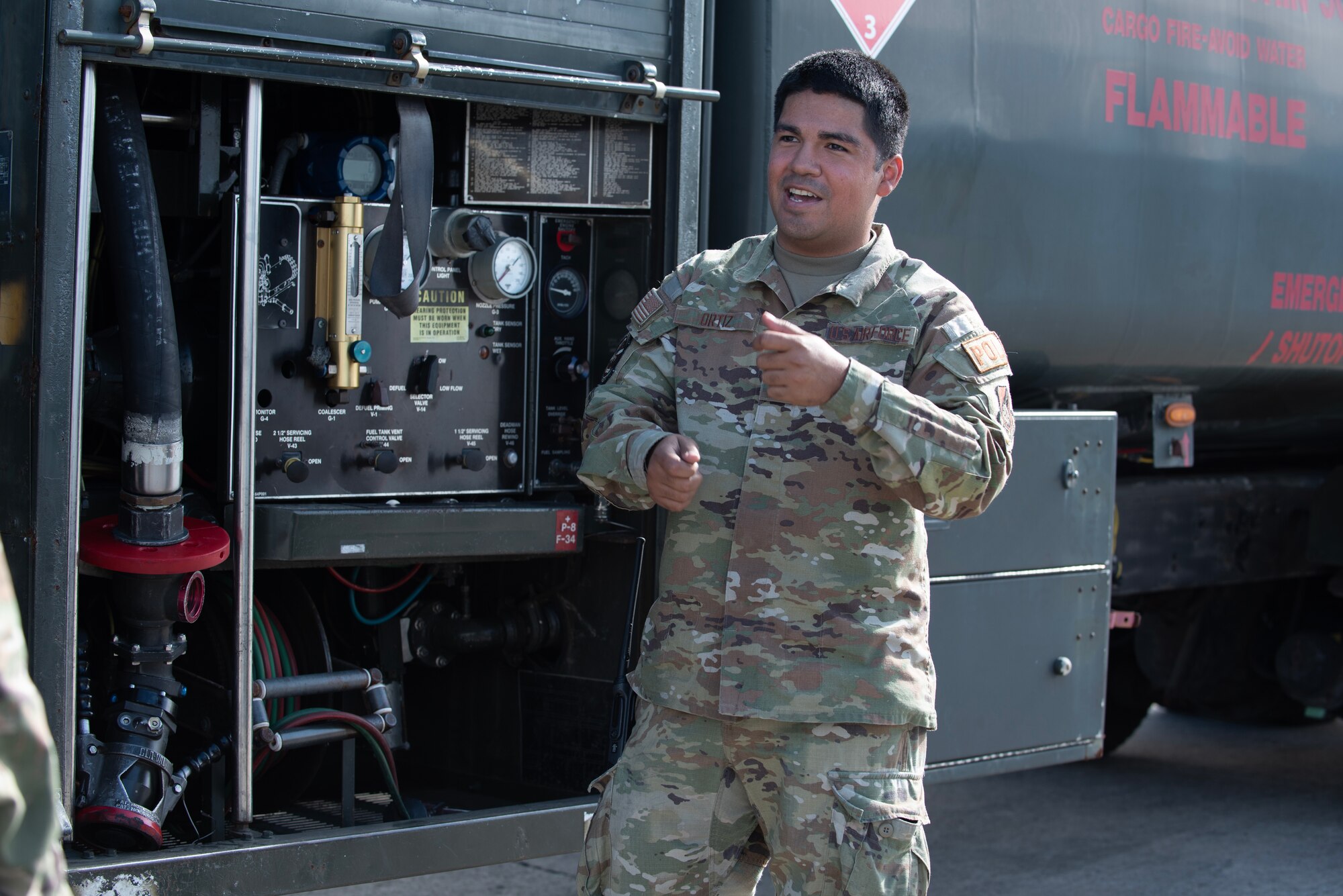 airmen talks to other airmen next to a refueling truck