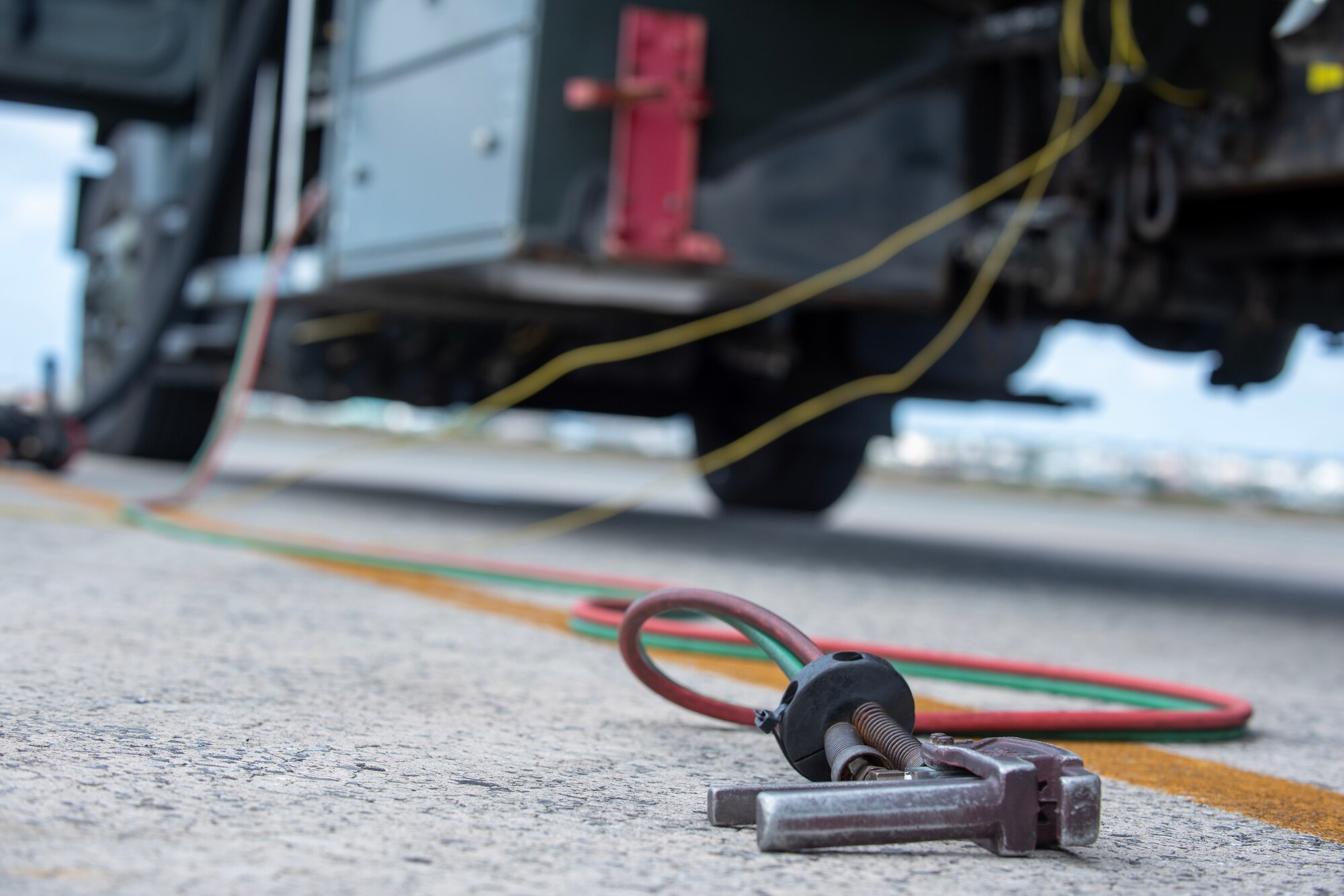 a switch lays on the ground next to a truck