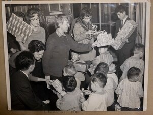 A photo of children receiving presents during a gift drive organized by Misawa Air Base in 1961, is held in a scrapbook at the Biko-en Children's Care Facility, Japan, Jan. 16, 2024.