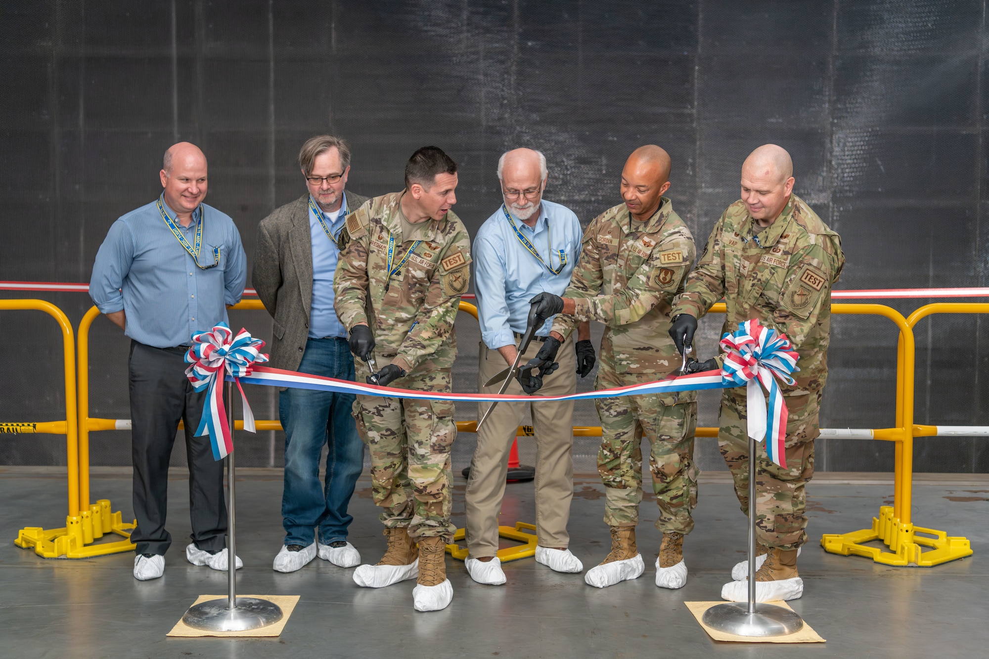Arnold Engineering Development Complex leaders and team members involved in the “honeycomb” installation undertaking cut the ribbon Nov. 6, 2023, to celebrate completion of the project in the 16-foot supersonic wind tunnel at Arnold Air Force Base, Tenn., headquarters of AEDC. The installation process was completed in October. (U.S. Air Force photo by Keith Thornburgh)