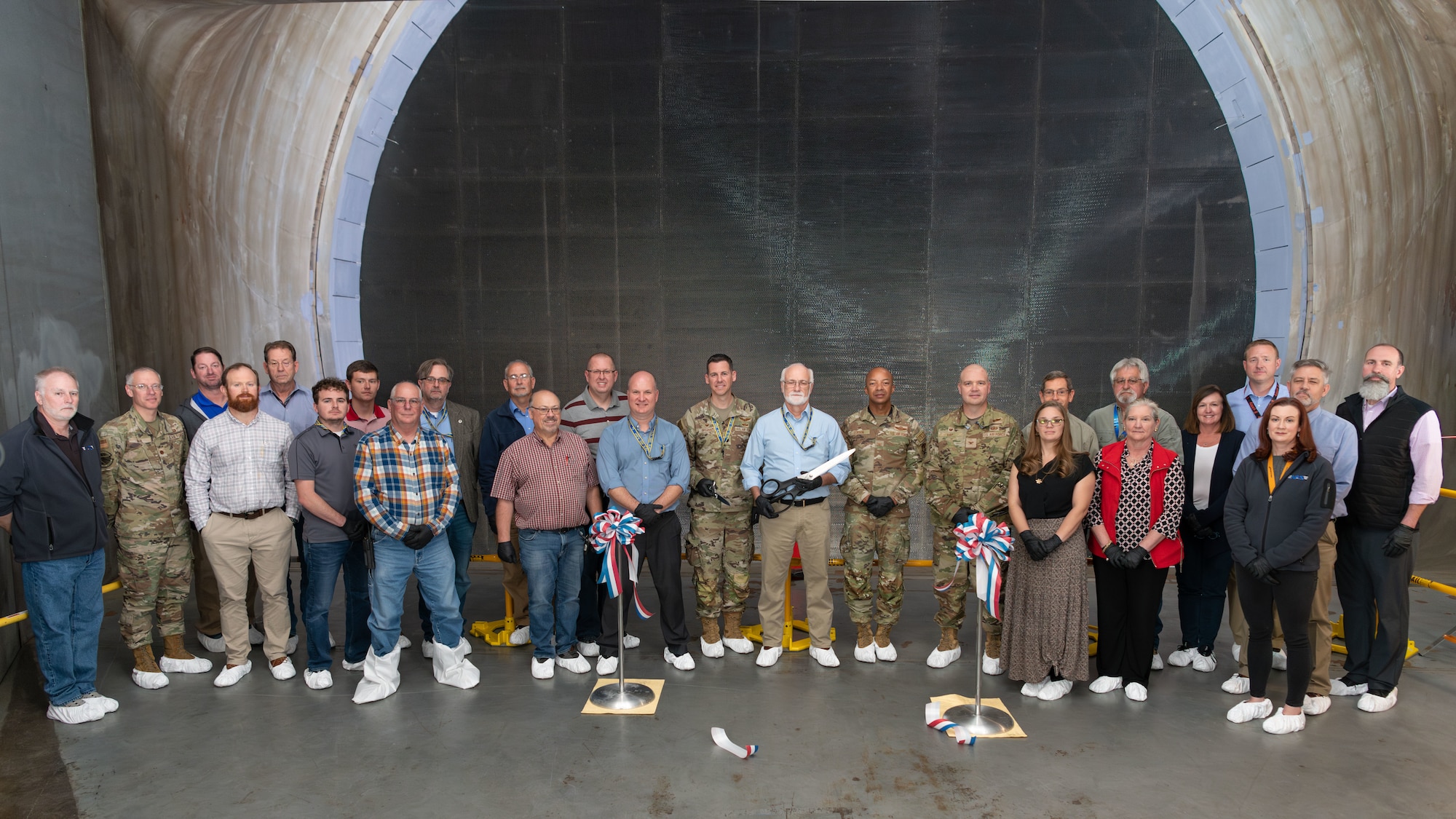 Arnold Engineering Development Complex leaders and team members involved with the “honeycomb” installation project gather for a photo in front of the recently-installed structure in the 16-foot supersonic wind tunnel at Arnold Air Force Base, Tenn., headquarters of AEDC. The installation process was completed in October. (U.S. Air Force photo by Keith Thornburgh)