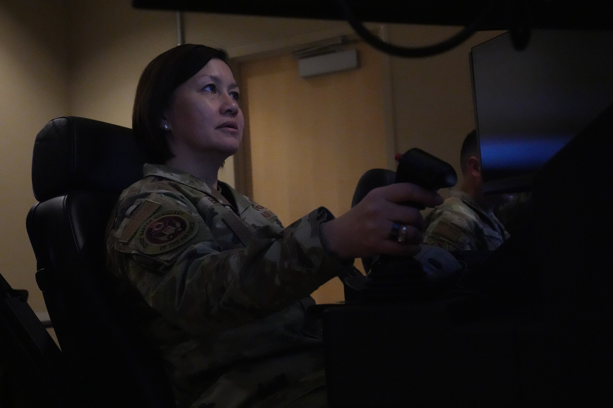Chief Bass sits in a simulator seat for an M-9 Reaper.