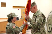 U.S. Army Brig. Gen. Laura A. McHugh, deputy adjutant general – Army, Pennsylvania National Guard, passes the regimental flag to Col. John M. Wenzel, the 166th Regiment - Regional Training Institute's incoming commander, during the regiment's change of command ceremony at Fort Indiantown Gap, Annville, Pa. Jan. 19, 2024.