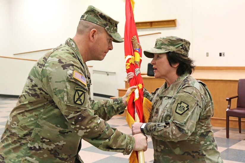 U.S. Army Col. Robert C. Jorgensen Jr., outgoing commander of the 166th Regiment - Regional Training Institute, passes the regimental flag to Brig. Gen. Laura A. McHugh, deputy adjutant general – Army, Pennsylvania National Guard during the regiment's change of command ceremony at Fort Indiantown Gap, Annville, Pa. Jan. 19, 2024.