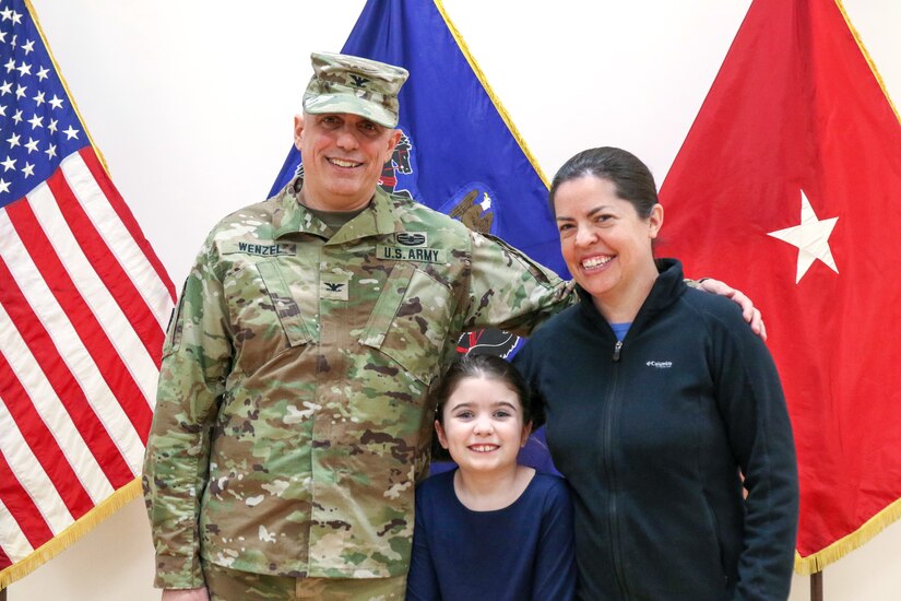 U.S. Army Col. John M. Wenzel, new commander of the 166th Regiment - Regional Training Institute, Pennsylvania Army National Guard poses for a family photo with his wife Virginia and daughter Anna following the regiment's change of command ceremony at Fort Indiantown Gap, Annville, Pa. Jan. 19, 2024.