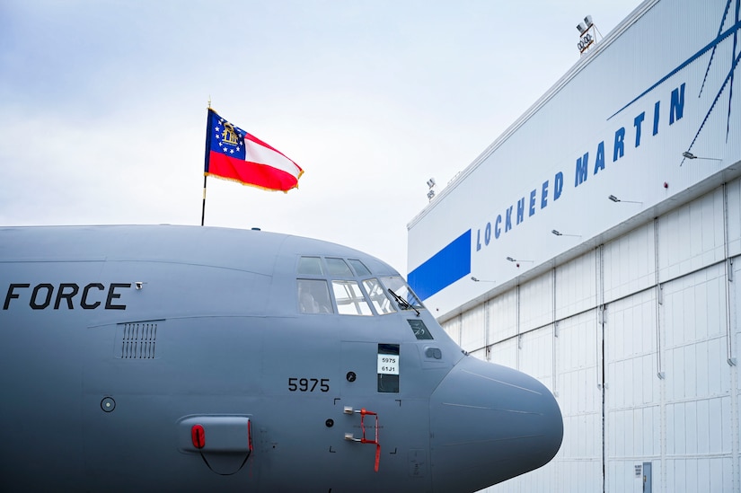 The cockpit of an aircraft as a flag flies above.