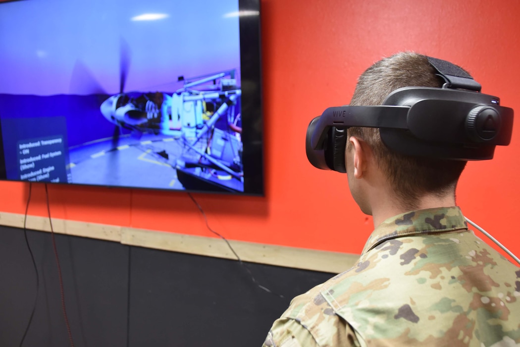 A person wearing a virtual reality headset faces a television screen.