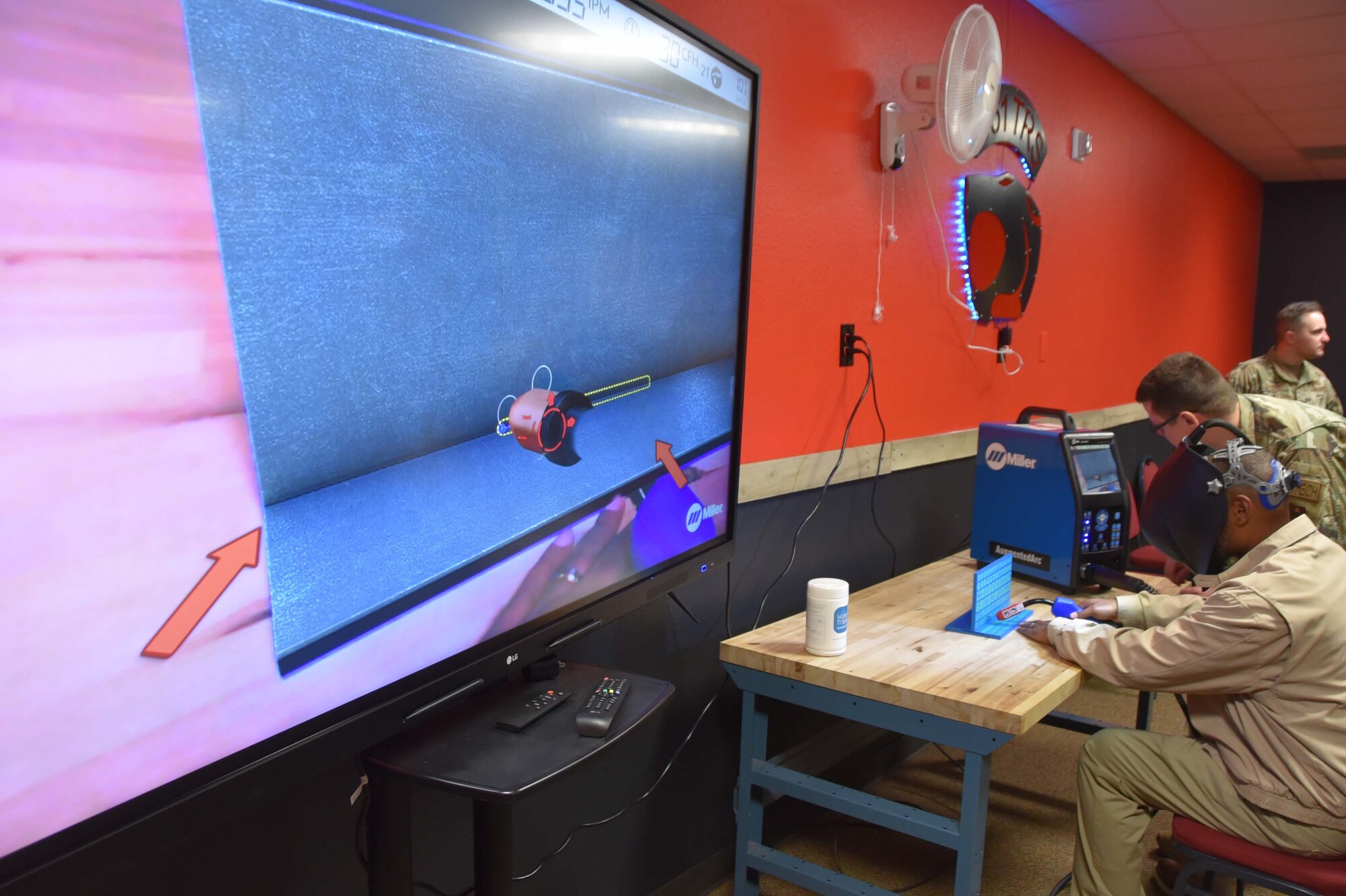 People wearing virtual reality headsets are sitting at a wooden table.