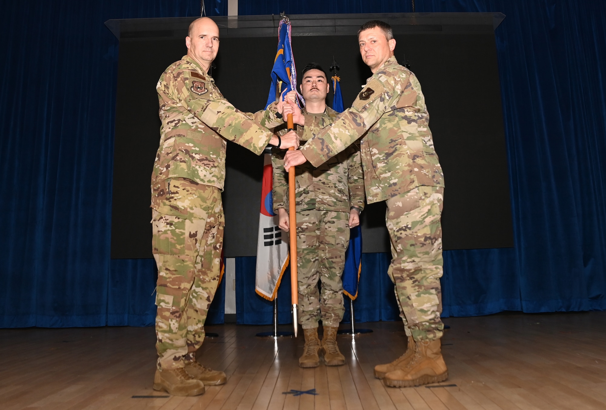 Brig. Gen. Ryan P. Keeney, left, 7th Air Force deputy commander, presents the guidon to Col. Tanner Woolsey, 607th Air Operations Center incoming commander, during an assumption of command ceremony at Osan Air Base, Republic of Korea, Jan. 11, 2024.