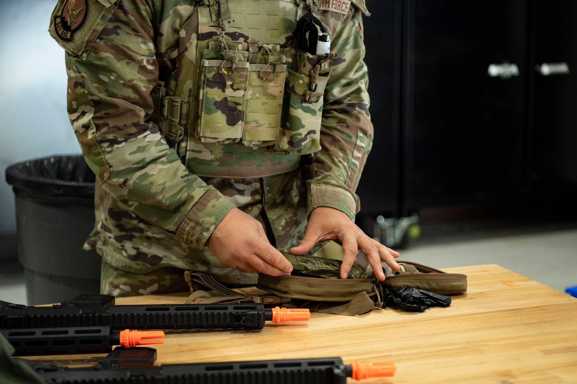 An Airman loads his TCCC pack before heading into a simulated scenario.