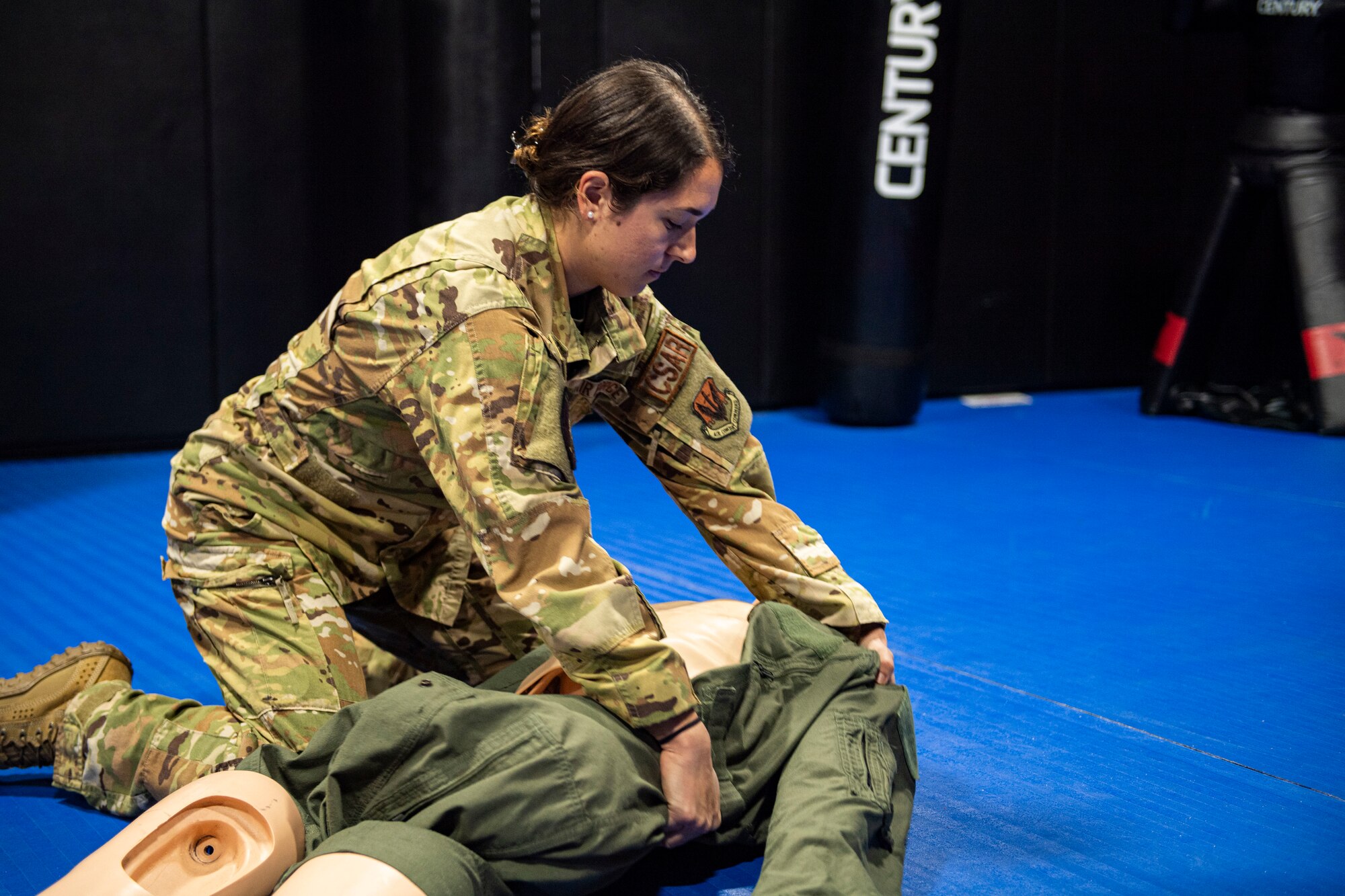 An Airman performs a head to toe check on a simulated casualty.