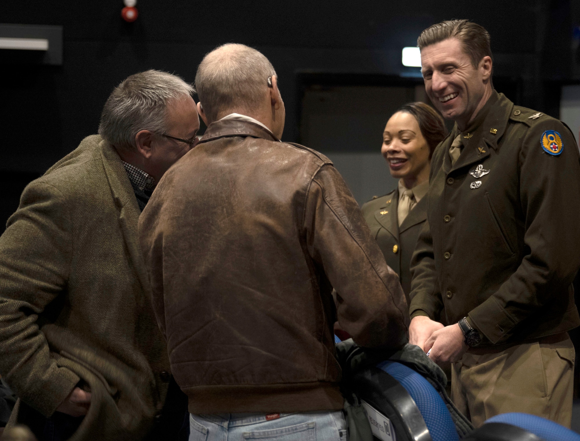 U.S. Air Force Col. Ryan Garlow, right, 100th Air Refueling Wing commander, and Chief Master Sgt. Tiffany Griego, second right, 100th ARW command chief, wear authentic World War II uniforms as they chat with invited guests before the start of the premiere of episode one of the upcoming “Masters of the Air” miniseries at Royal Air Force Mildenhall, England, Jan. 19, 2024. The upcoming nine-part series on Apple TV+ highlights the legacy of the Eighth Air Force and 100th Bomb Group at Thorpe Abbotts, England, to which the 100th ARW has direct ties. (U.S. Air Force photo by Senior Airman Alvaro Villagomez)
