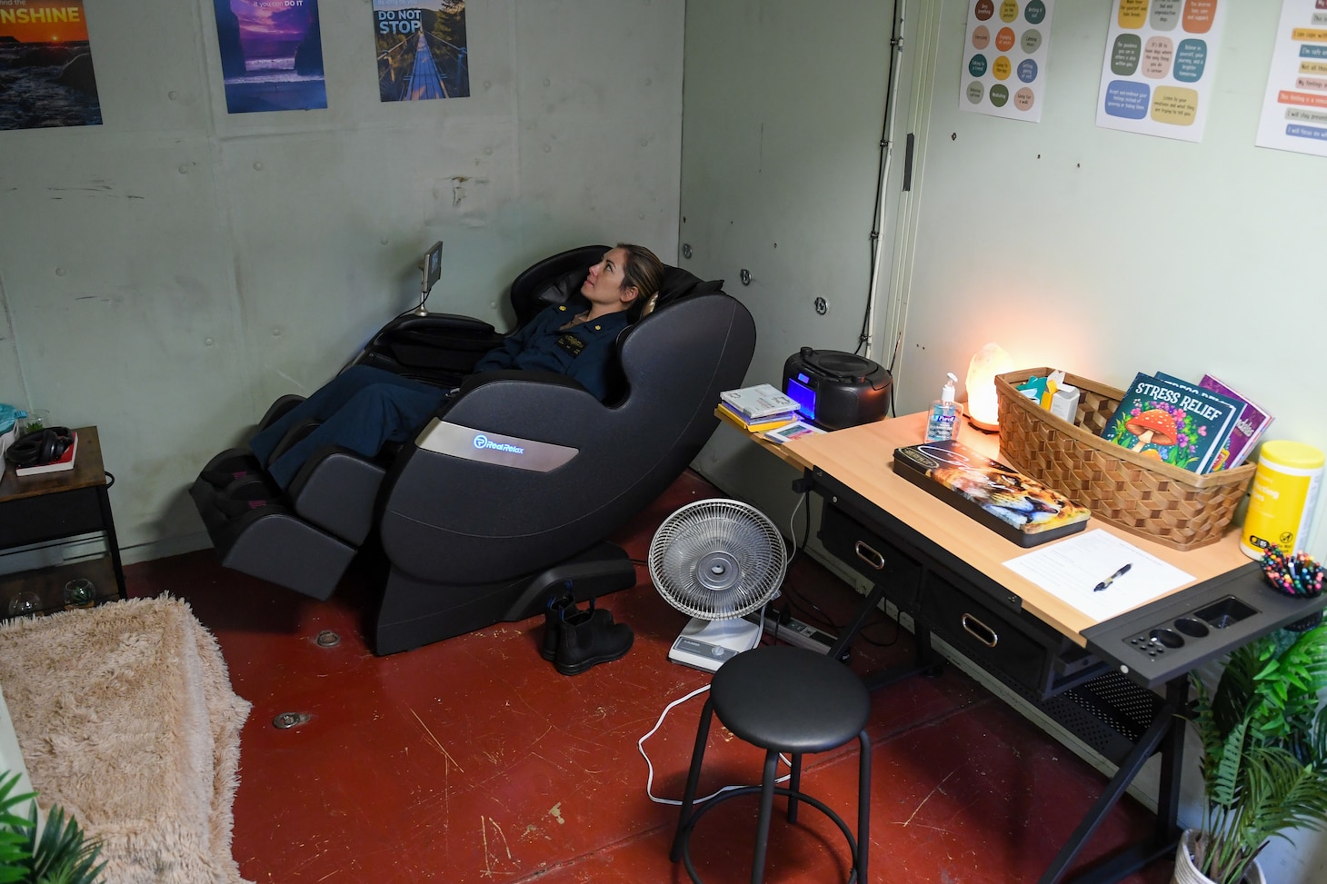 U.S. Lt. Cmdr. Katie Lee, an ER doctor, relaxes in a massage chair in the resiliency room aboard the hospital ship USNS Mercy (T-AH 19) underway in the Pacific Ocean, as part of Pacific Partnership 2024-1, Jan. 23, 2024. Pacific Partnership, now in its 19th iteration, is the largest multinational humanitarian assistance and disaster relief preparedness mission conducted in the Indo-Pacific and works to enhance regional interoperability and disaster response capabilities, increase security stability in the region, and foster new and enduring friendships. (U.S. Navy photo by Mass Communication Specialist 3rd Class Justin Ontiveros)