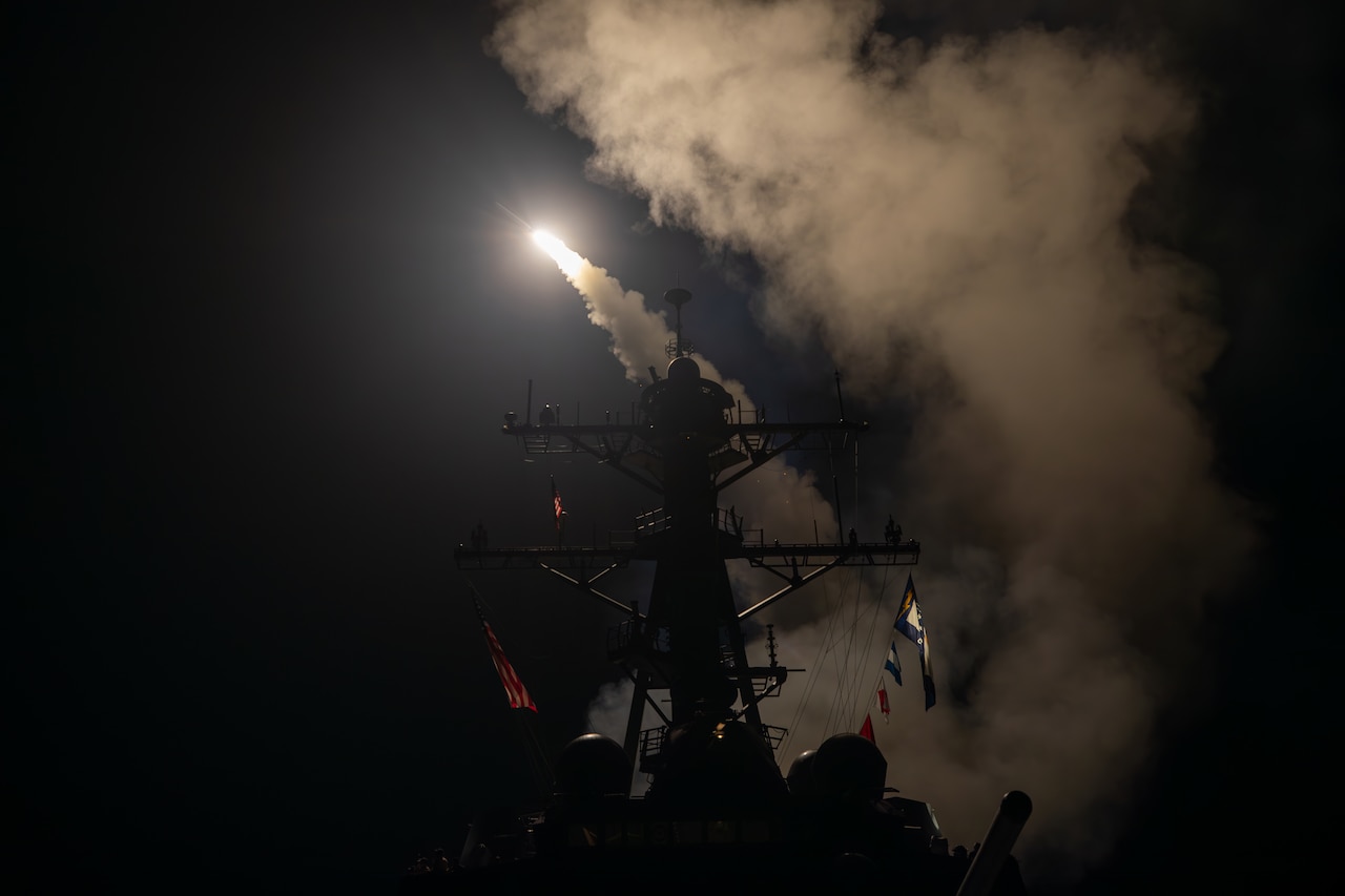 A missile launches from a ship.