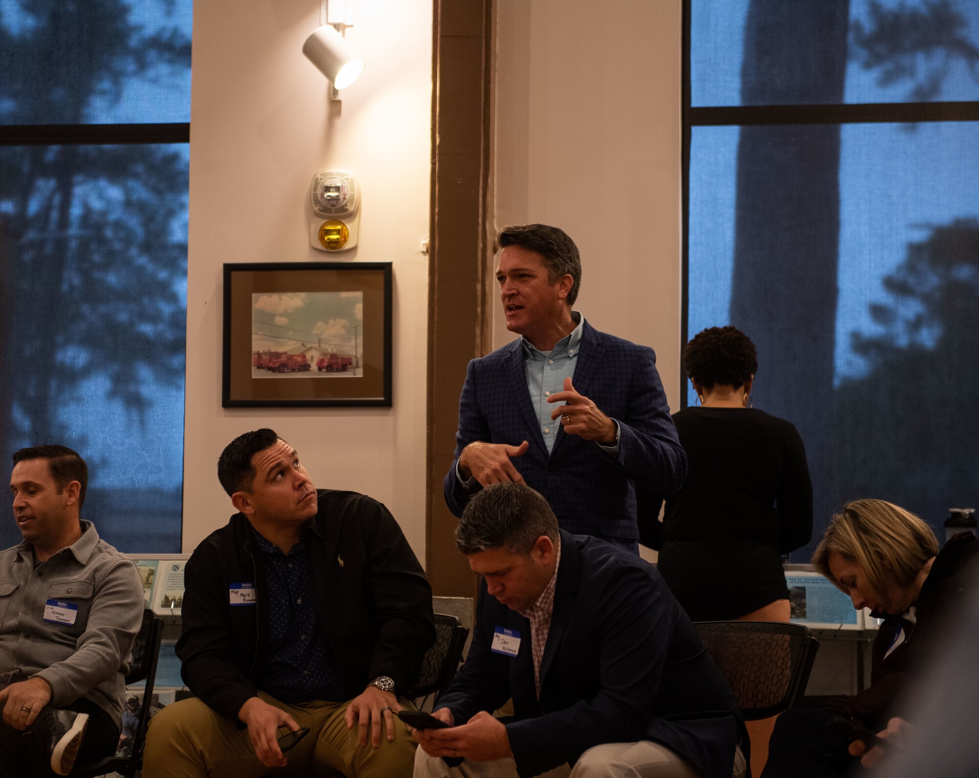 An local community leader speaks to a group of Airmen