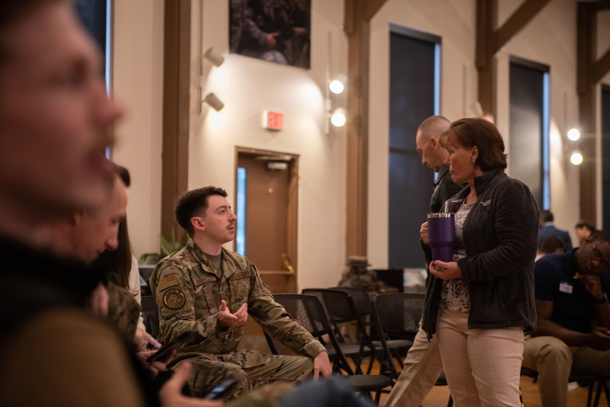 An Airman talks to a local community leader at emerge moody
