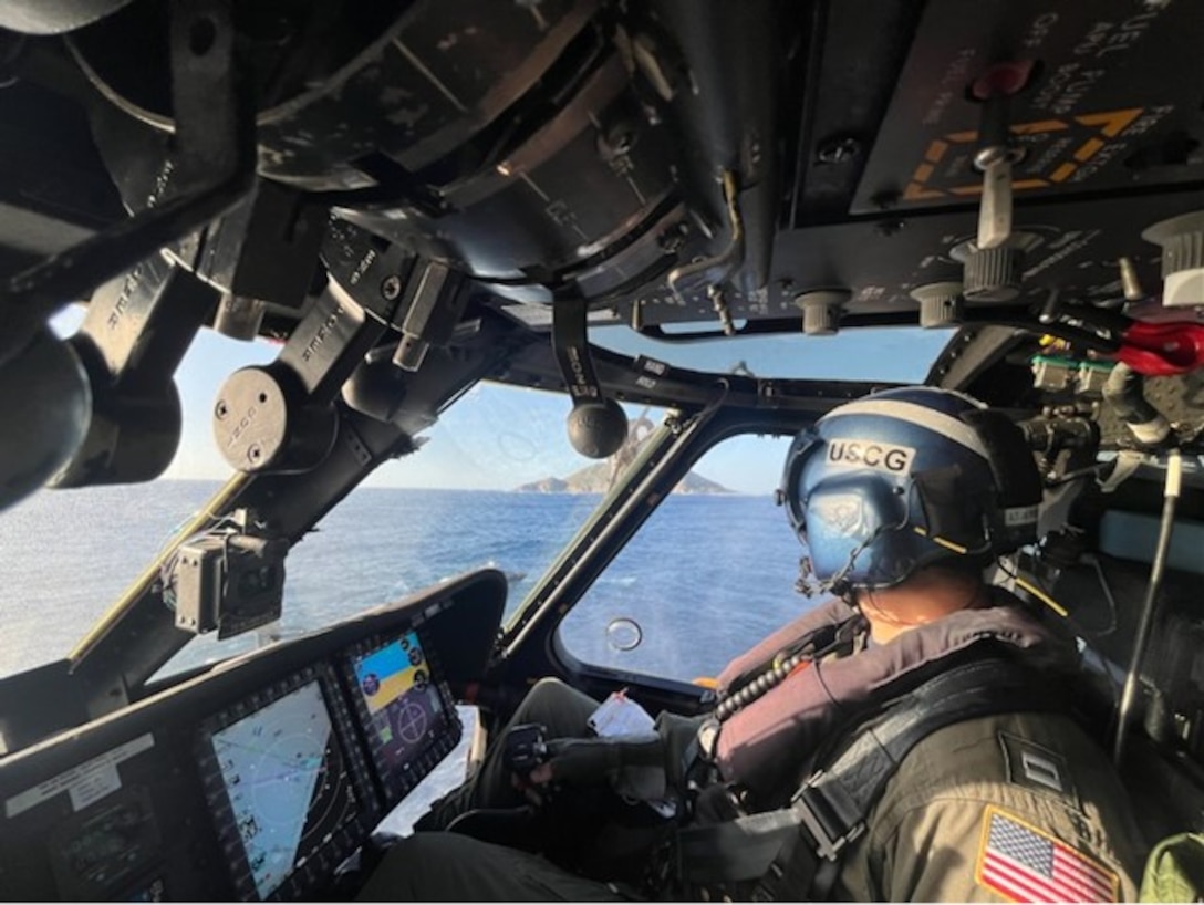 A Coast Guard MH-60T Jayhawk aircrew responding to a vessel capsizing flies top cover while a Puerto Rico Police Joint Forces of Rapid Action marine unit rescues three boaters from a capsized vessel just off Desecheo Island, Puerto Rico, Jan. 23, 2024. All three boaters were safely transported to the Police Joint Force of Rapid Action Boat Station in Añasco, Puerto Rico, no injuries or medical concerns were reported in this case.  (U.S. Coast Guard photo)