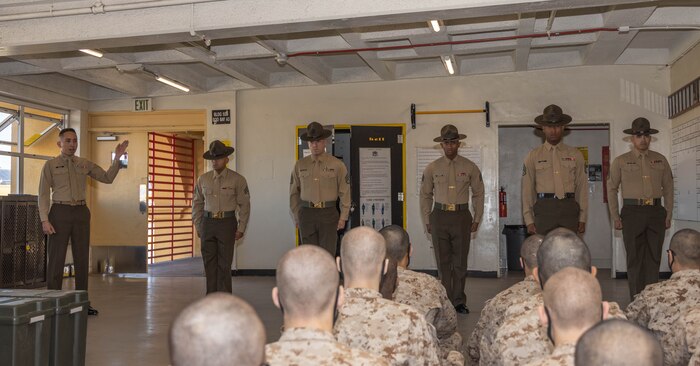 U.S. Marine Corps Capt. Javier A. Baca, series commander for Hotel Company, 2nd Recruit Training Battalion, introduces drill instructors for Hotel Company during pick up at Marine Corps Recruit Depot, San Diego, Jan. 16, 2024. Recruits were introduced to their drill instructors, where they gained an understanding of the rules and expectations set for their training. (U.S. Marine Corps photo by Lance Cpl. Janell B. Alvarez)