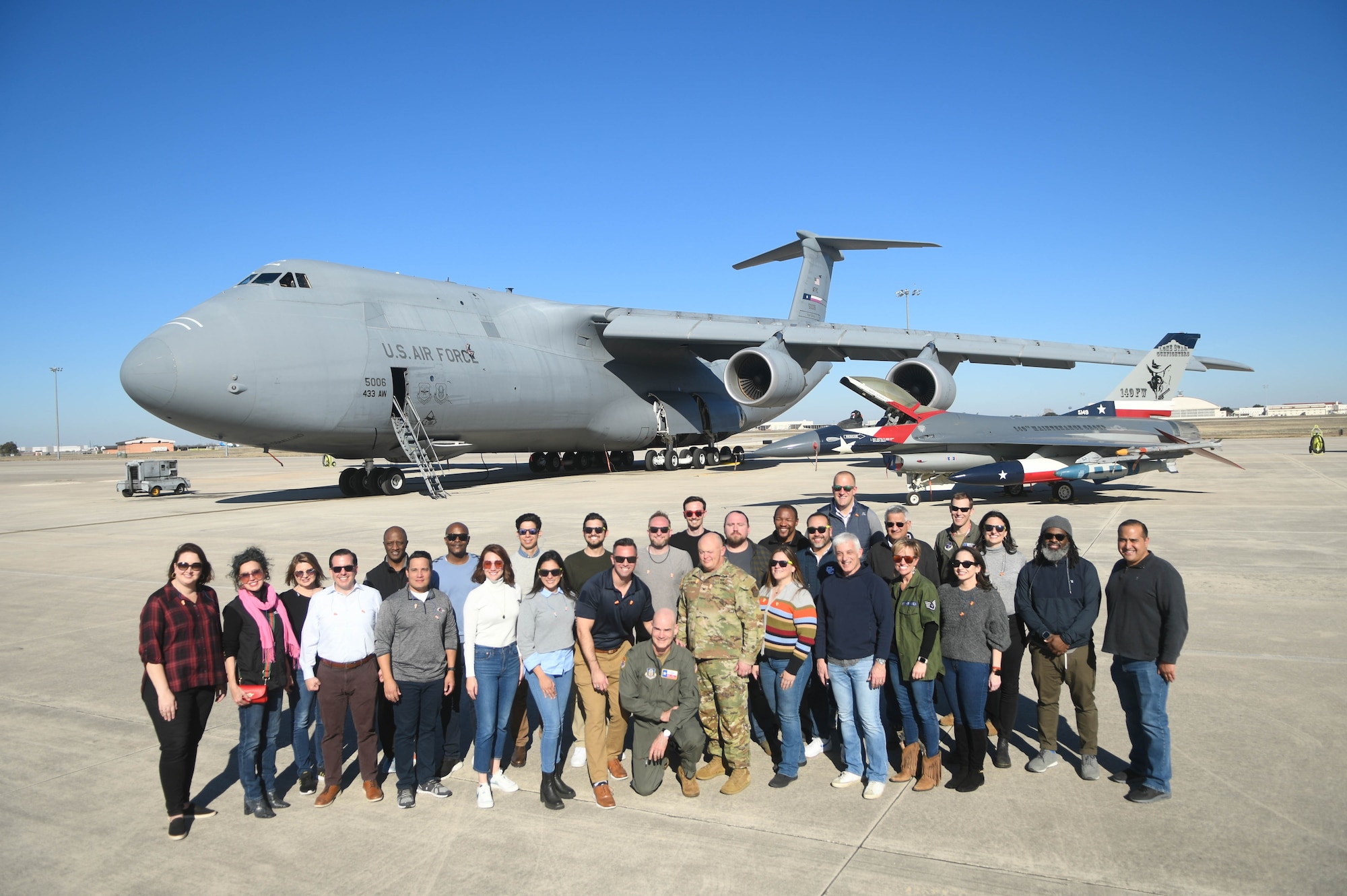 Leadership San Antonio members and leadership from across Joint Base San Antonio including Col. William Gutermuth, center, 433rd Airlift Wing commander, pose for a photo on the flight line on Joint Base San Antonio-Lackland, Texas Jan. 18, 2024.