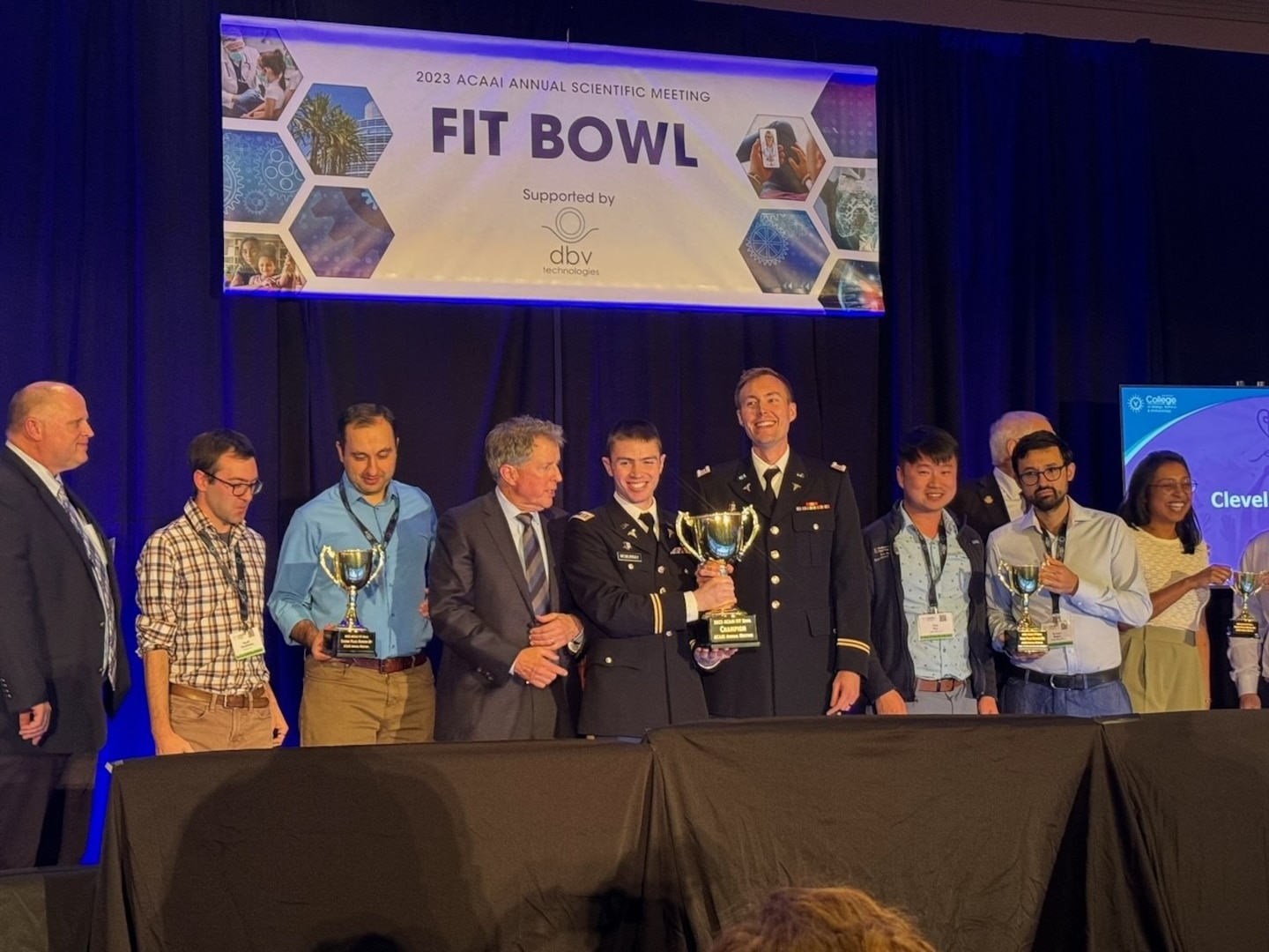 Army Capts. (Drs.) Jerry McMurray and Andrew Weskamp (center), from the National Capital Consortium and Walter Reed, hold the 2023 Champion Trophy from the FIT Bowl they earned Nov. 11 during the competition among allergy/immunology fellowship programs from across the country held in Anaheim, California.