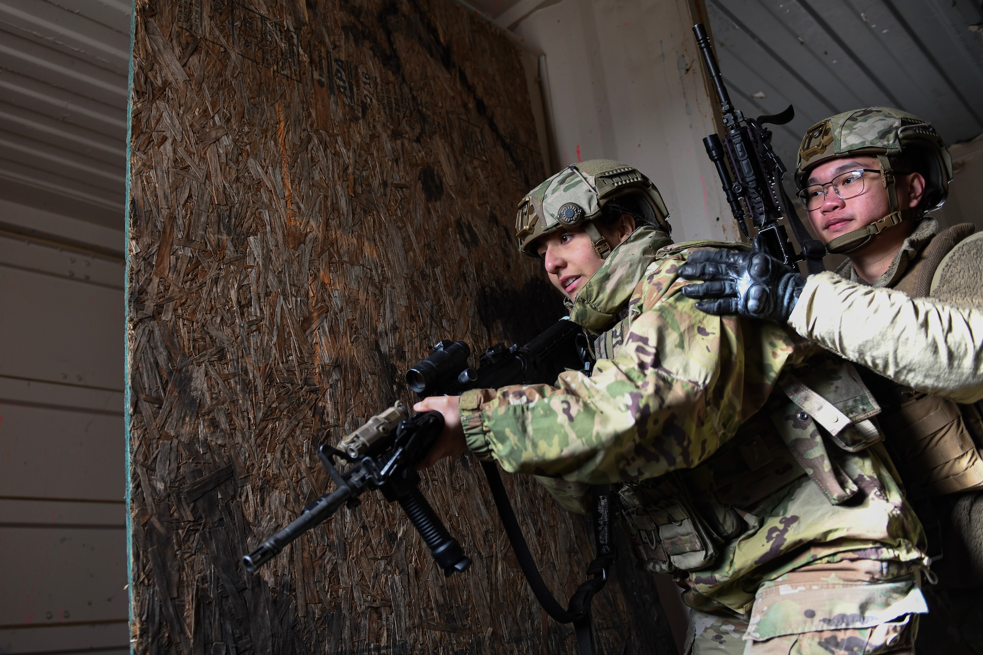 Airmen search a building