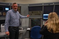A photo of Bill Thompson in front of several machines.