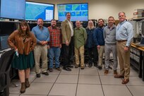 A photo of several people posing.