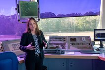 A photo of Melanie Hoy in an air traffic control tower.
