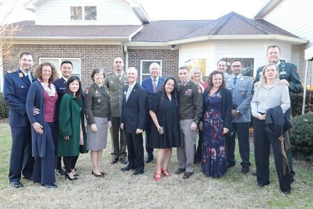 U.S. Army Cyber Commanding General, Lt. Gen. Maria Barrett, CCoE Commanding General, Maj. Gen. Paul Stanton and wife Mrs. Naomi Stanton, pose with Foreign Liaison Officers during the Fort Eisenhower annual New Year's Reception.