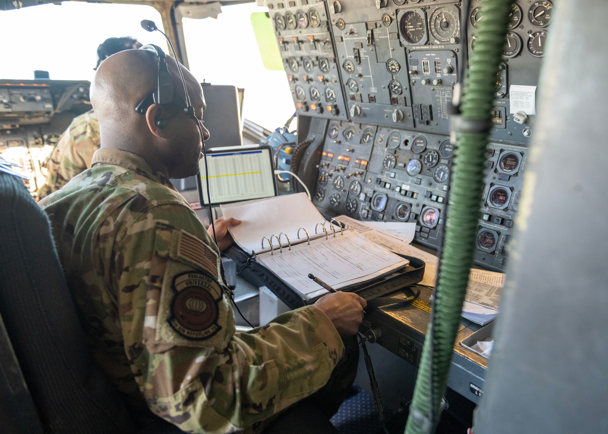 U.S. Air Force Master Sgt. Van Stewart, 9th Air Refueling Squadron KC-10 Extender flight engineer, checks aircraft maintenance forms prior to flight.