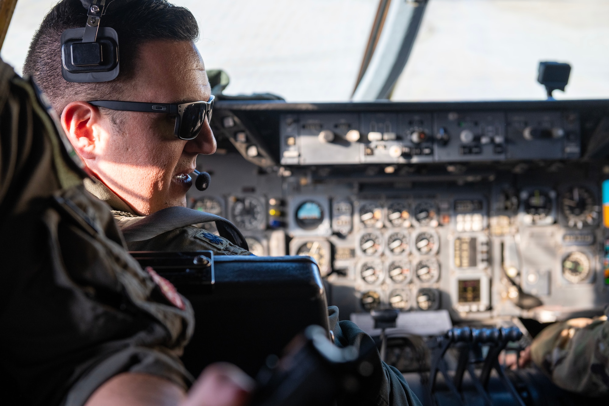 U.S. Air Force Lt. Col. Andrew Baer, 9th Air Refueling Squadron commander and KC-10 Extender pilot, communicates to fellow aircrew members prior to starting engines on the aircraft.
