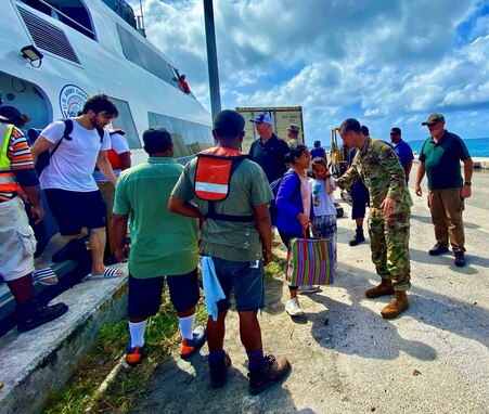 U.S. Army Garrison – Kwajalein Atoll Commander Col. Drew Morgan, center right, welcomes Roi-Namur evacuees to Kwajalein Island on Jan. 21. Roi-Namur is a four-hour boat trip from Kwajalein.