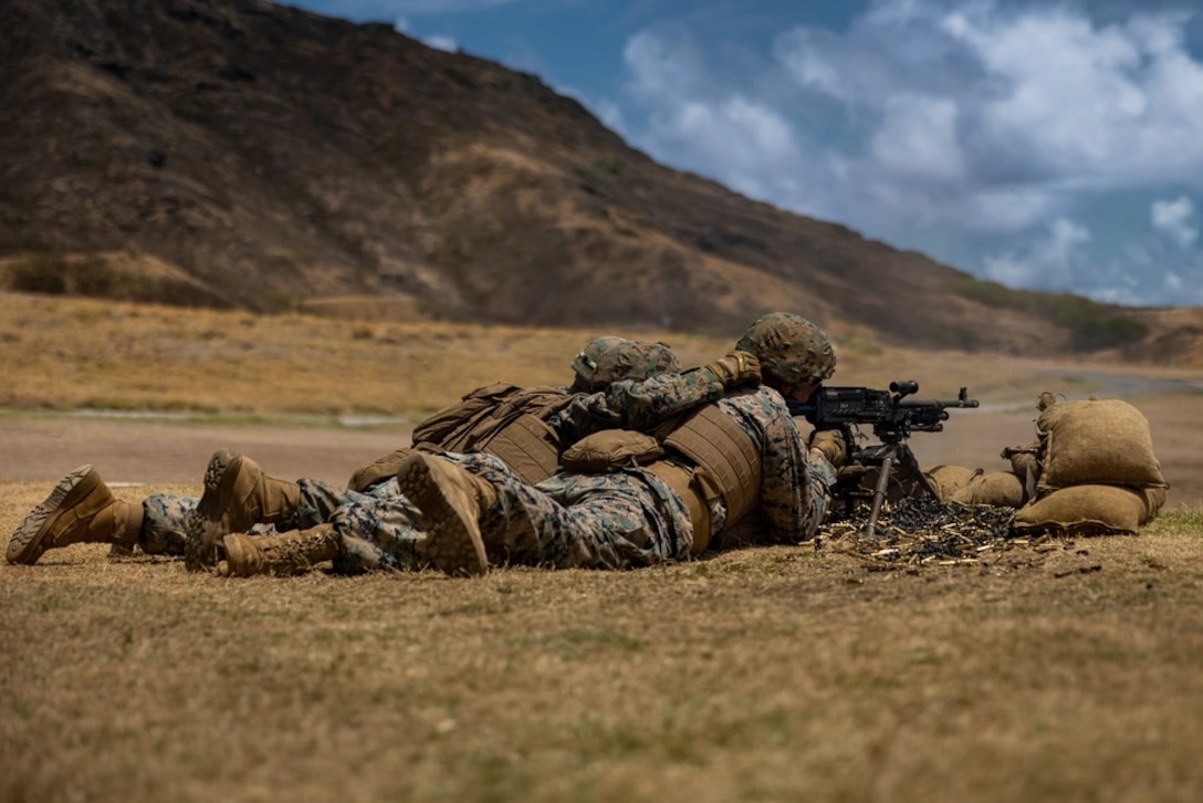 U.S. Marines with 3d Radio Battalion, III Marine Expeditionary Force Information Group, fire an M240B machine gun during a multi-weapons systems range at Marine Corps Base Hawaii, August 14, 2023. The purpose of this training is to sharpen the Marines’ weapons handling skills and increase their readiness for future exercises and operations. Alpha Company, 3d Radio Battalion, provides support to 3d Marine Littoral Regiment during various training exercises.