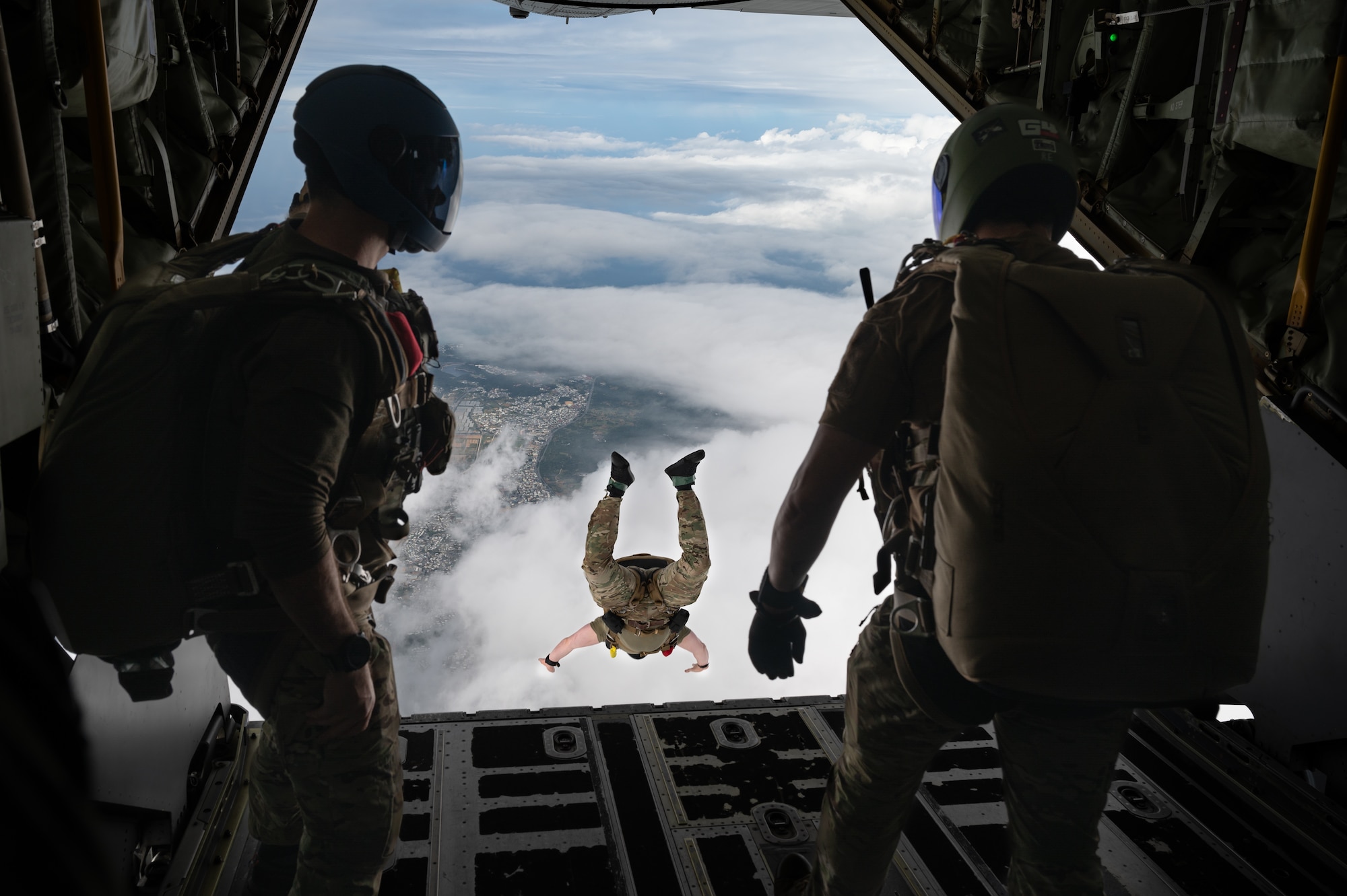 Pararescuemen jump out of an MC-130J.