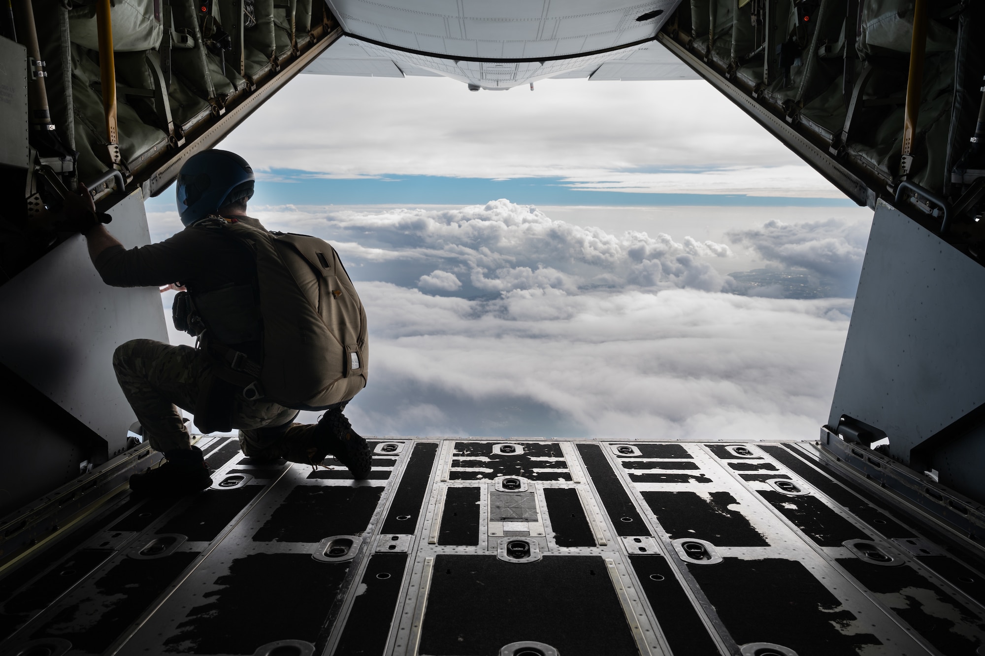 A pararescueman prepares to jump out of an MC130J- Commando II.