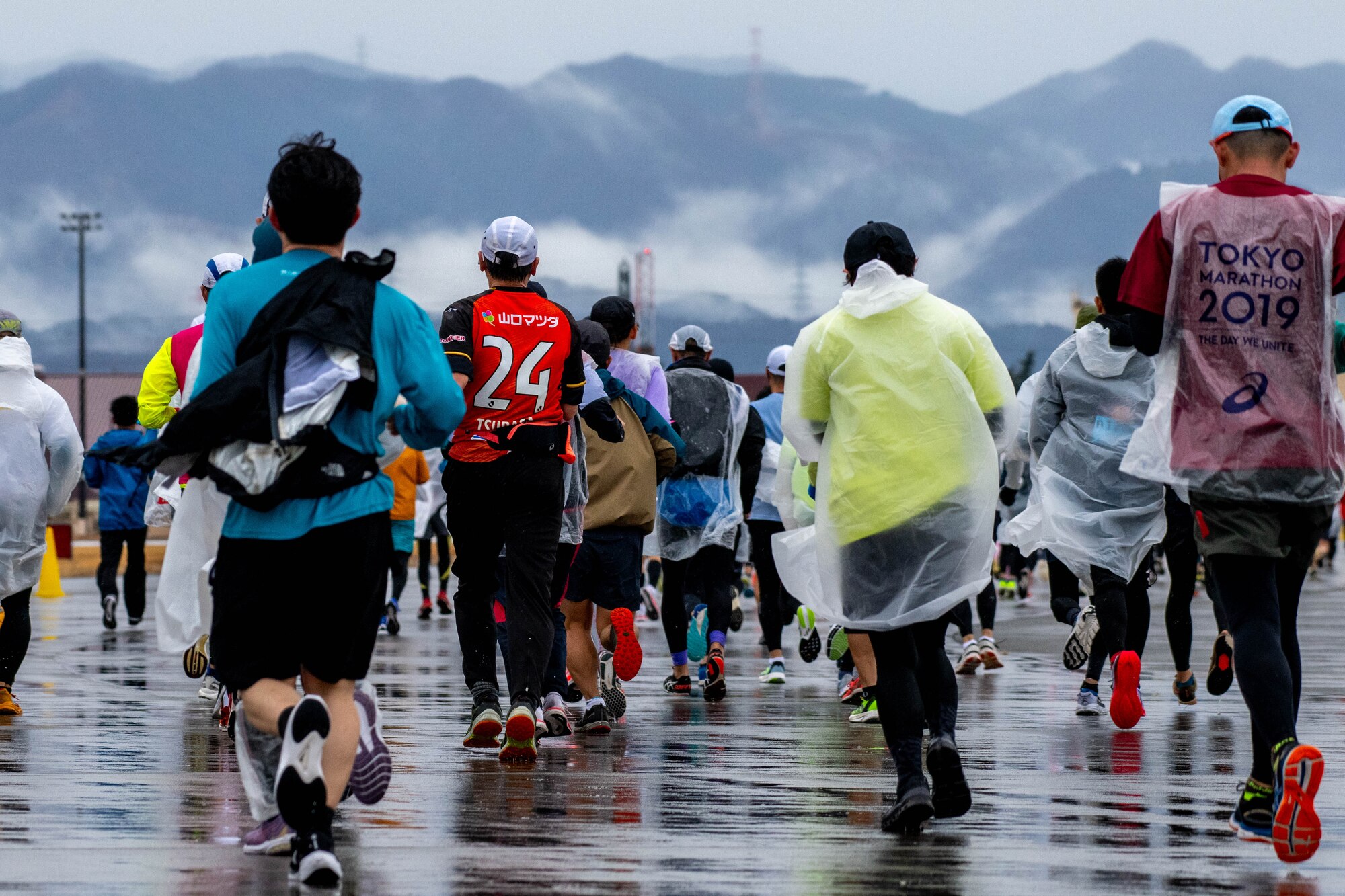 Runners participating in the half-marathon event make their way down the flightline.