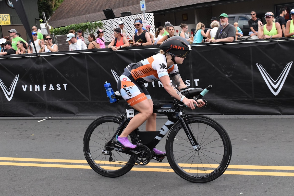 A photo of a person riding a racing bicycle.