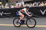 A photo of a person riding a racing bicycle.