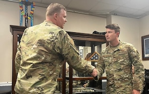 Col. Philip Warlick II, 655th Intelligence, Surveillance, and Reconnaissance (ISR) Wing commander, coins then-Tech. Sgt. Tristan Wentworth, 28th Intelligence Squadron, for being recognized as the Wing’s Air Force Intelligence, Surveillance and Reconnaissance Award Program (AFISRAP) Non-Commissioned Officer of the Year. Wentworth was promoted to master sergeant Nov. 1, 2023.
