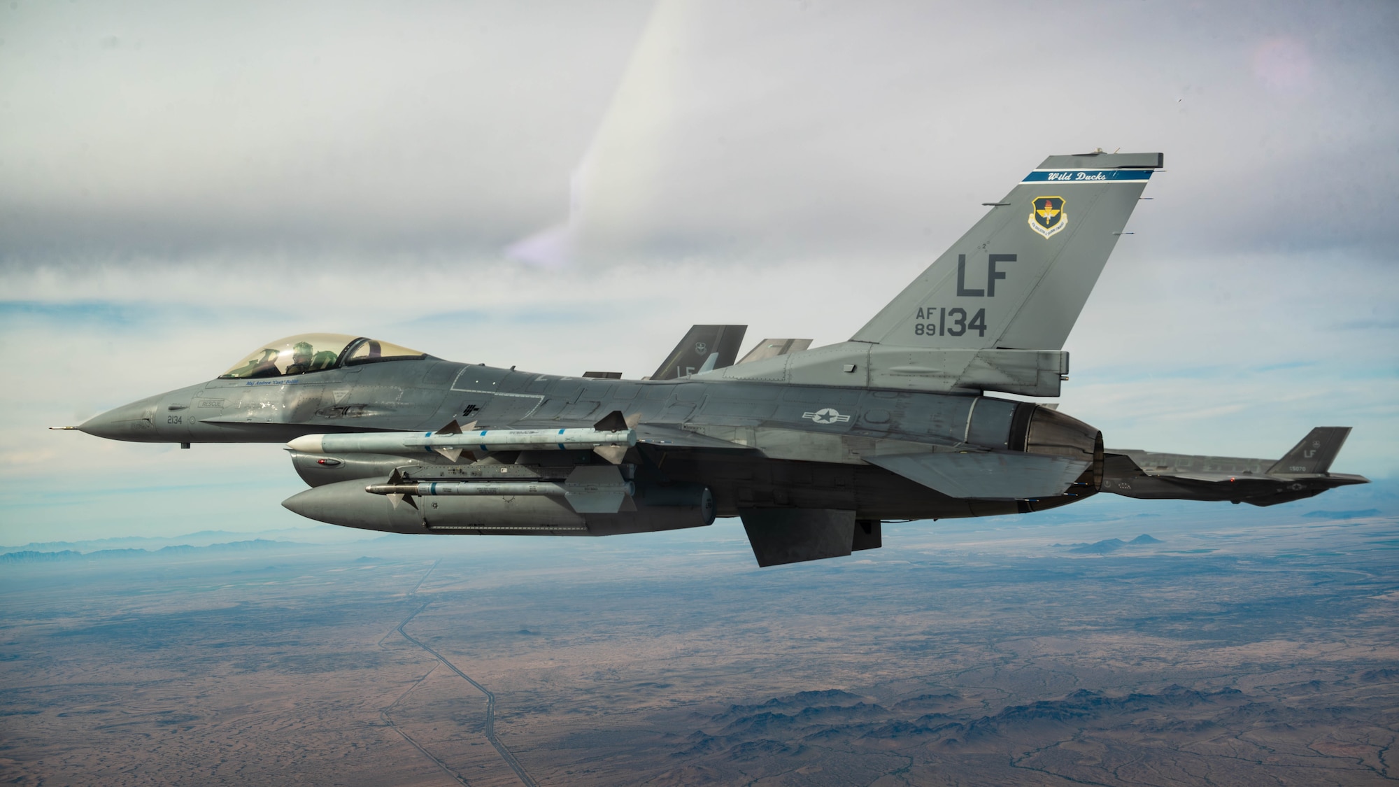 A U.S. Air Force F-16 Fighting Falcon aircraft assigned to the 309th Fighter Squadron and F-35A Lightning II’s assigned to the 61st Fighter Squadron, fly in formation, Jan. 19, 2024, over Luke Air Force Base, Arizona.