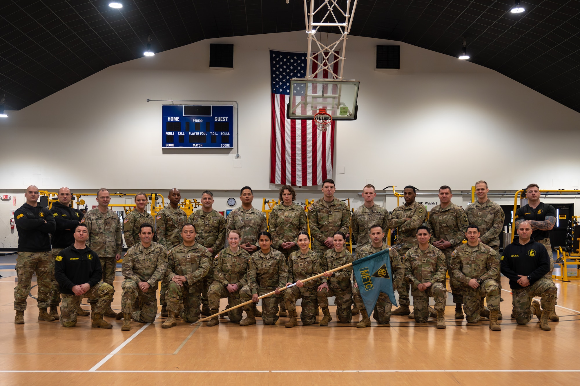 U.S. Army Soldiers pose for a graduation photo.