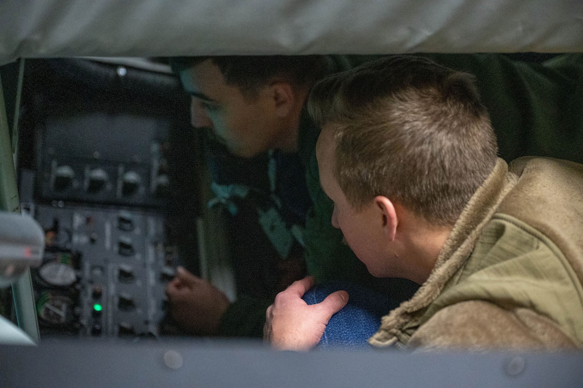 U.S. Air Force Tech. Sgt. Alex Esquibel (left), 54th Air Refueling Squadron instructor boom operator, shows 1st. Lt. Joshua Gentry, 82nd Training Wing chaplain, the inside of a KC-135 Stratotanker Boom Operator Weapon System Trainer (BOWST) during a tour at Altus Air Force Base, Oklahoma, Jan. 19, 2024. Gentry saw how the BOWST provided hands-on training for students. (U.S. Air Force Photo by Airman First Class Heidi Bucins)
