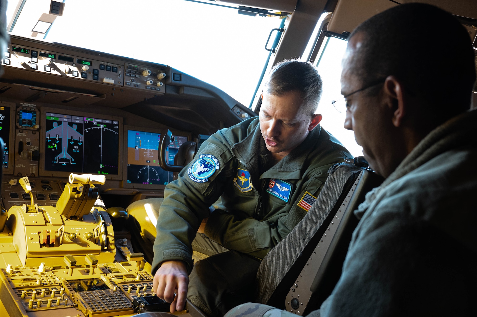 U.S. Air Force Staff Sgt. Austin Wilson (left), 56th Air Refueling Squadron instructor boom operator, shows Maj. Manuel Duarte, 82nd Training Wing chaplain, the cockpit of a KC-46A Pegasus during a tour at Altus Air Force Base (AFB), Oklahoma, Jan. 19, 2024. The event hosted chapel staff from Sheppard and Vance AFB to share best practices and experience the mission of the 97th Air Mobility Wing. (U.S. Air Force Photo by Airman First Class Heidi Bucins)