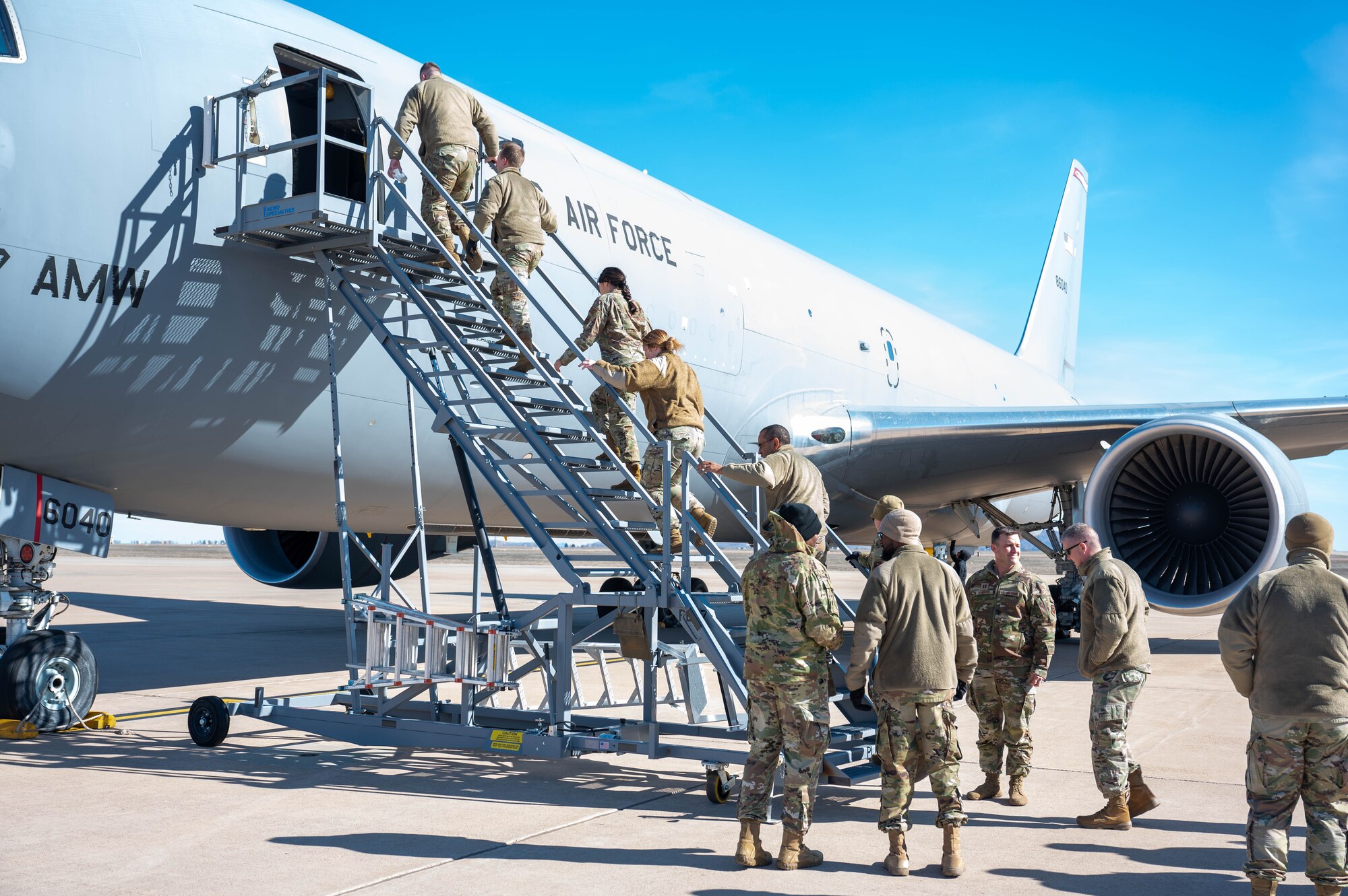 Chapel members from Altus, Sheppard, and Vance Air Force Base enter a KC-46A Pegasus aircraft at Altus Air Force Base, Oklahoma, Jan. 19, 2024. The group toured the static display and witnessed the mission at the 97th Air Mobility Wing. (U.S. Air Force photo by Airman First Class Heidi Bucins)