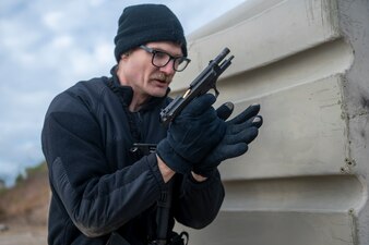 U.S. Navy Chief Gunner’s Mate Michael Strobeck, a combat systems leading chief petty officer assigned to the San Antonio class amphibious transport dock USS New York (LPD-21), loads a magazine into a M9 pistol during a weapons qualification course on Joint Expeditionary Base Little Creek Fort Story, Jan. 19, 2024.