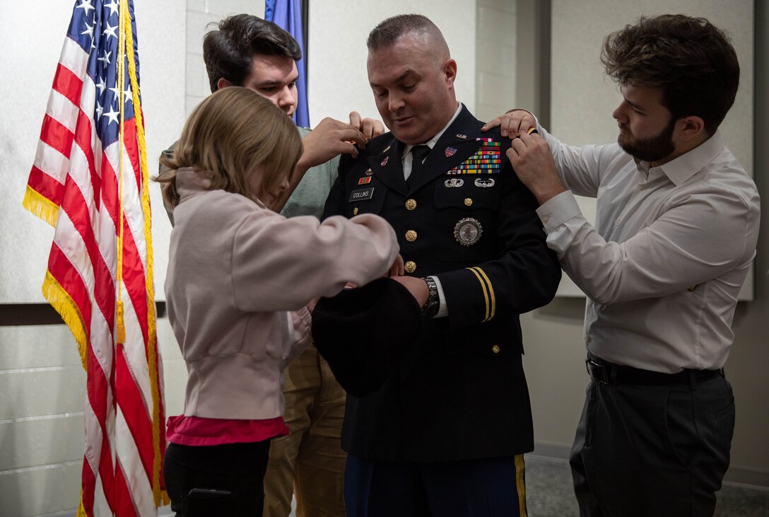 Chief Warrant Officer Four Timothy Collins' children pin on his ranks during his promotion ceremony at the Wellman Auditorium on the Boone Center in Frankfort, Kentucky Jan. 22, 2024.  His children enjoyed doing this for their father. (Kentucky Army National Guard photo by Sgt. Destini Keene)