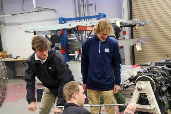 240122-N-MY408-1104 NAS OCEANA, VA (Jan. 22, 2024) Connor Robertson (left) and Chase Amos (right), two high school students from Advanced Technology Center’s Naval Architecture & Ocean Engineering course in Virginia Beach who submitted essays on what their Navy means to them, cycle a M61A1 20-millimeter gatling gun while touring Strike Fighter Squadron (VFA) 106 “Gladiators” hangars and facilities at Naval Air Station Oceana. (U.S. Navy photo by Lt. j.g. Daniel Ehrlich)