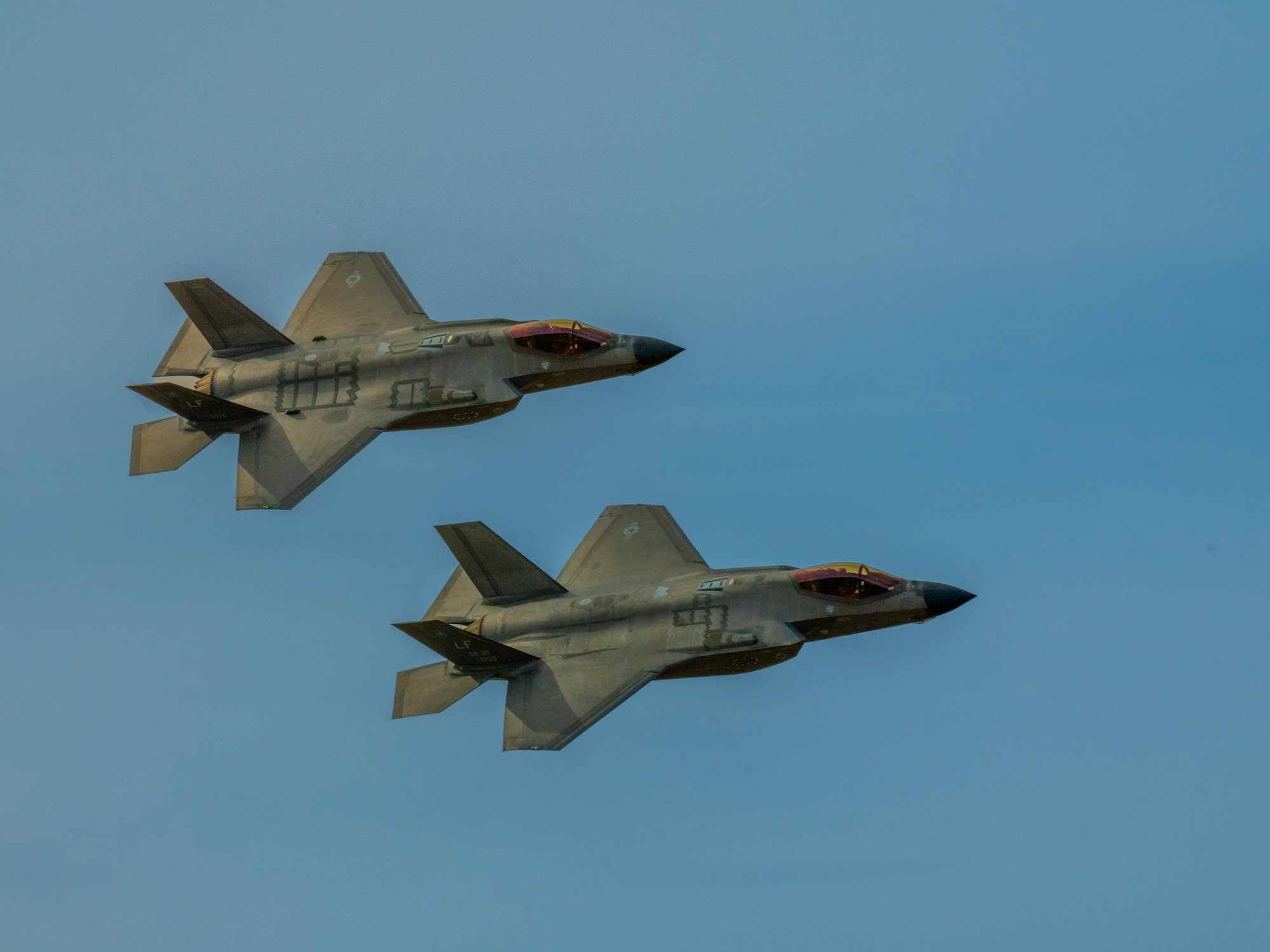 Two F-35 Lightning II assigned to the 56th Fighter Wing fly over Barry M. Goldwater Range, Arizona, Jan. 19, 2024.