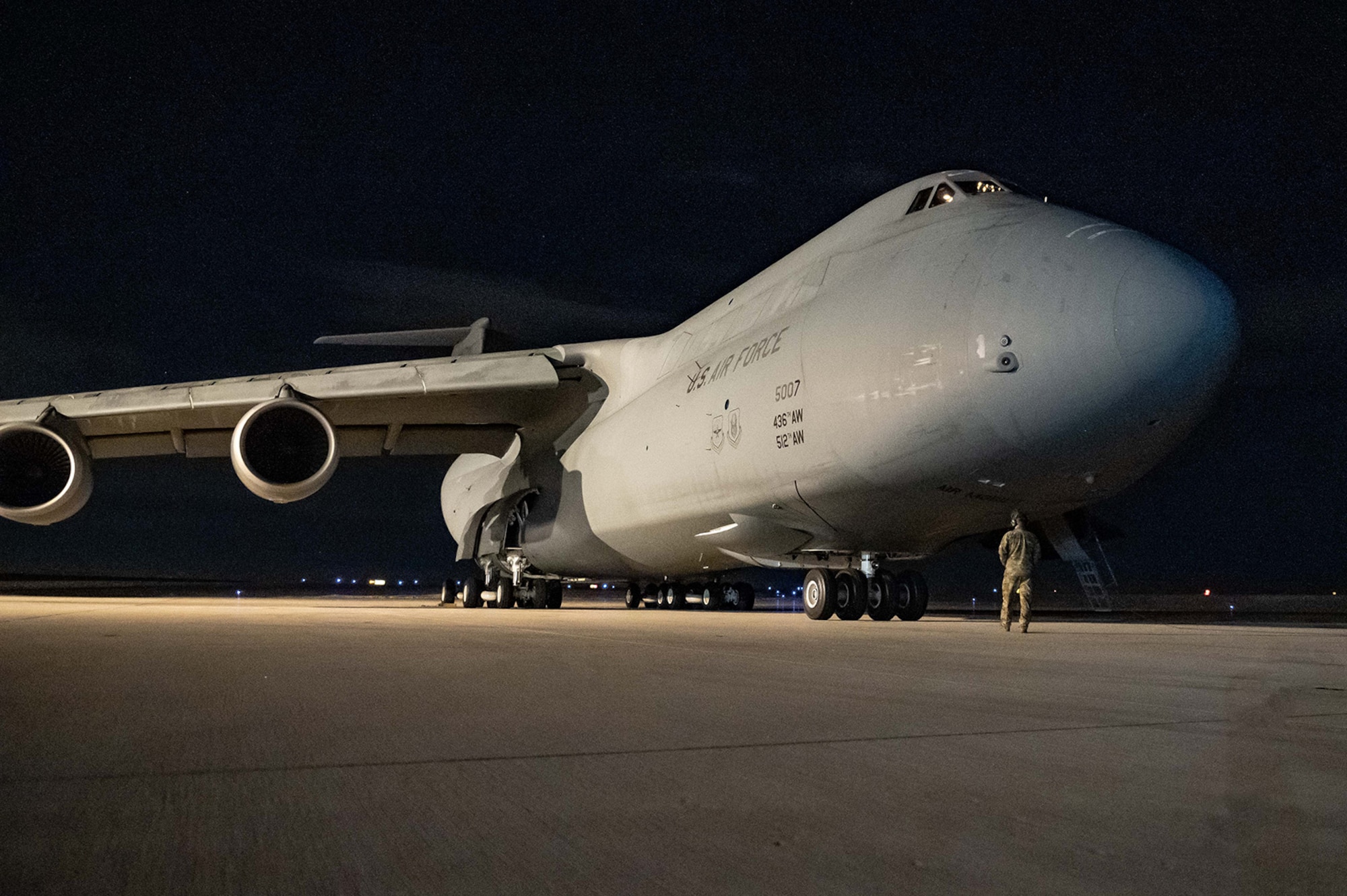 A C-5M Super galaxy sits on a flightline.