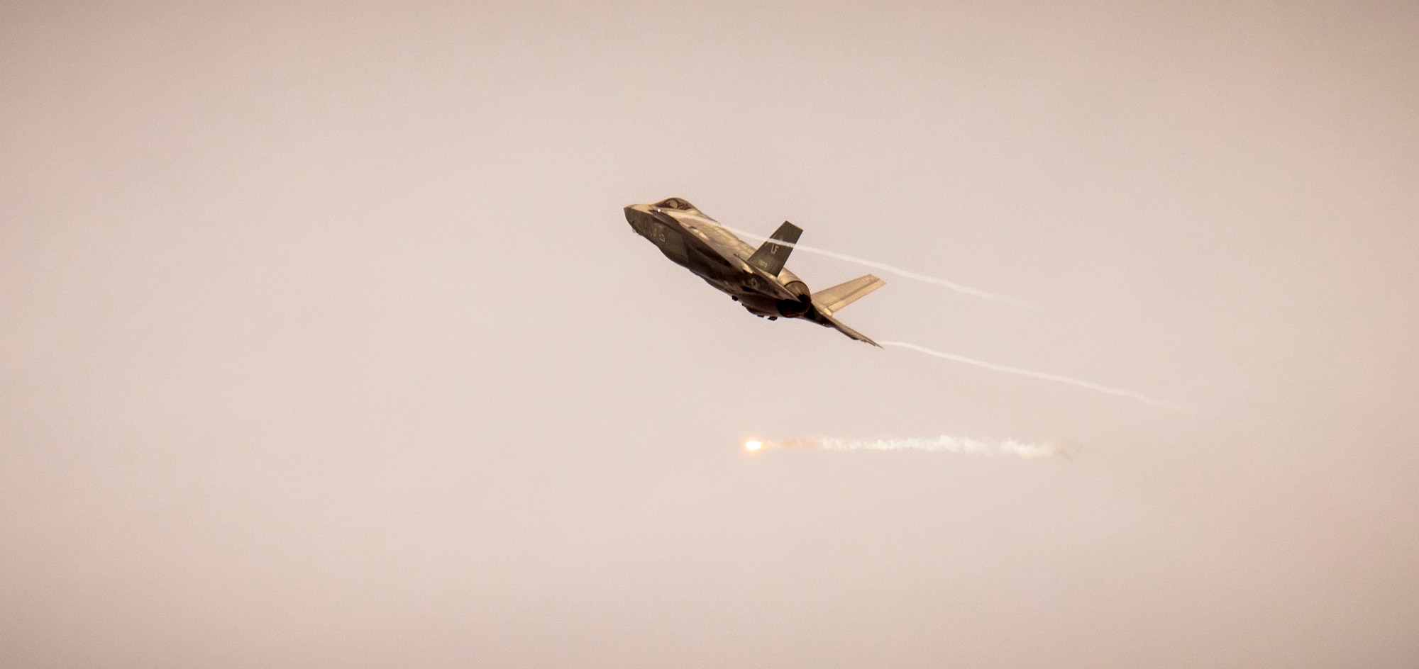An F-35 Lightning II assigned to the 61st Fighter Squadron, Luke Air Force Base, Arizona, fires a flare over Barry M. Goldwater Range, Arizona, Jan. 19, 2024.